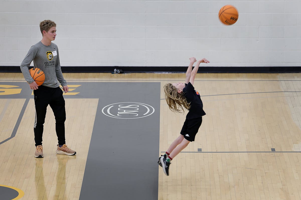 Cross Country runner, Diego Escalante ’28, left, plays basketball with Clay, 7, during Parent’s Night Out on Saturday, Dec. 6, 2025